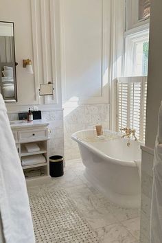 a white bath tub sitting next to a window