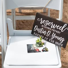 a white chair with a sign that says reserved to the bride and groom on it