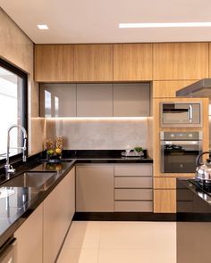 an image of a modern kitchen setting with black counter tops and stainless steel appliance