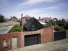 a brick house with an open garage door