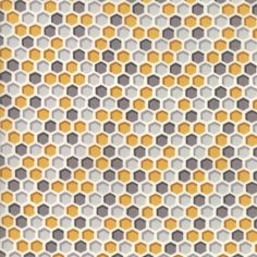 an orange, grey and yellow geometric pattern on white fabric with hexagonal shapes