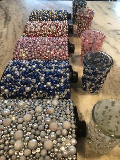 a table topped with lots of different colored beads