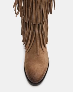 Upgrade your wardrobe with the SPUR fringe boot. These boots feature a fringe detailing that adds a touch of effortless style. Perfect for any occasion, these boots will elevate your look while providing comfort and durability. 1 inch heel height 14.5 inch shaft circumference 15 inch shaft height Suede upper material Synthetic lining Leather sock Synthetic sole Fit tip: If you are in between sizes, size up a half-size Imported Casual Leather Fringe Boots, Casual Suede Fringe Boots, Leather Fringe Boots For Fall, Winter Suede Boots With Tassels, Casual Fringe Boots For Fall, Western Fringe Boots For Fall, Winter Fringe Ankle Boots, Western Suede Fringe Boots, Western Suede Boots With Tassels