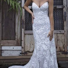 a woman in a wedding dress posing for the camera