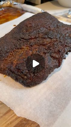 a piece of meat sitting on top of a wooden cutting board