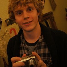 a young man taking a selfie with his camera