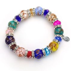 "This multi colored  bracelet is hand made in Venice, Italy using authentic Murano Glass.  Our glass master artisans create each bead by hand.  Each bead has a mineral called \"aventurine\" blown into the glass to add a beautiful sparkle.  Crystal spacers in between the colorful Murano glass beads.  Each bracelet comes with a certificate of authenticity stating that it is made of authentic Murano glass from Venice, Italy. Stretch bracelet fits wrists 7-9\"" Multicolor Bracelet, Murano Glass Beads, Glass Bracelet, Colorful Bracelets, Venice Italy, Stretch Bracelet, Murano Glass, Stretch Bracelets, Arm Band