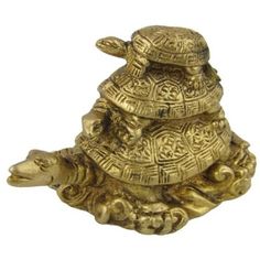 a golden turtle statue sitting on top of it's back