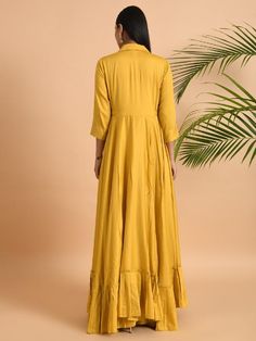 A shawl collared cotton silk maxi dress with flared and flounced bottom, side pockets, and long sleeves Garment measurements (in Inches): Small: Bust - 39", Waist - 29" Medium: Bust - 42", Waist - 32" Large: Bust - 45", Waist - 35" Length: 55-56", Sleeve length: 17" Fabric: Cotton Silk Color: Yellow Fit: Model height is 5'7" Model is wearing a size S Loose and comfortable fit. Instructions: Hand wash separately in cold water Note: Available in other colors Pants not included with the product Pan Anarkali Floor-length Dress With Ruffles, Festive Ruffled Maxi Dress, Festive Maxi Dress With Ruffles, Anarkali Dresses With Ruffles, Fitted Anarkali Dress With Ruffles, Festive Ruffled Long Sleeve Dress, Festive Long Sleeve Dresses With Ruffles, Festive Long Sleeve Ruffled Dress, Anarkali Long Sleeve Gown