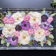 an arrangement of flowers in a clear vase