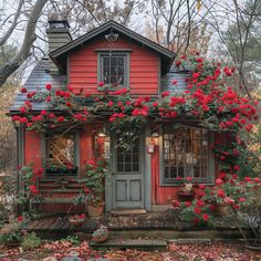 a red house with flowers growing on it's roof