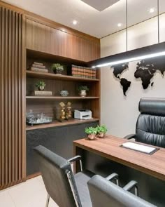 an office with a wooden desk and black leather chairs