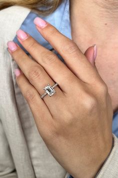 a woman's hand with a diamond ring on it