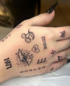 a person's hand with tattoos on it