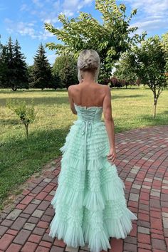 Expertly crafted from tulle material in a stunning mint green color, this gown features an A-line silhouette and a strapless neckline. With a high waist and full length tiered ruffle skirt, it also boasts a high-low hemline and a built-in bra for added support. SKU: 3446 Mint green color Tulle material A-line silhouette Strapless neck High waist Full length Tiered ruffle skirt High low Built-in bra Ship in 7-10 business days Size: US 2-16. We offer free returns in 7 days. Please refer to our return policy page for more details. If you have any questions, don't hesitate to contact us: at service@dressesforparty.com. Formal Prom Dresses Long, Ruffle Prom Dress, Ruffle Gown, Green Tulle, Tulle Sleeves, Floor Length Prom Dresses, Wedding Dresses With Flowers, Wedding Flower Girl Dresses, Tiered Ruffle Skirt