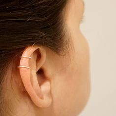 A unique ear cuff that clips onto the ear without the need for piercings. A great earring for those who do not have the piercing but want the look! + Material - Stainless Steel, Titanium, Sterling Silver, Yellow Gold Fill, Rose Gold Fill, 14k Gold + Ring Size - 8mm Diameter + Cuff Length - 9mm long + Price is for one Ear cuff! + Packaged in Brown Kraft box NOTE This Earring does not require a pierced ear! The model is wearing the sterling silver option and that is the option shown in the picture Minimalist Everyday Internally Threaded Ear Cuff, Adjustable Minimalist Hoop Ear Cuff, Adjustable Minimalist Huggie Wrap Earrings, Minimalist Adjustable Huggie Wrap Earrings, Adjustable Nickel Free Minimalist Wrap Earrings, Minimalist Adjustable Nickel-free Wrap Earrings, Adjustable Hypoallergenic Minimalist Ear Cuff, Minimalist Adjustable Pierced Ear Cuff, Minimalist Pierced Adjustable Ear Cuff