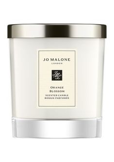 an orange blossom candle with a silver lid on a white background and the words jo malone written