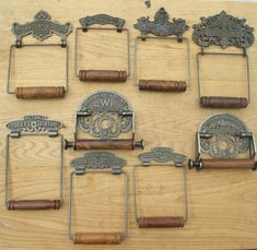 twelve antique style metal bottle openers with wooden handles on a wood surface, some are made in the usa