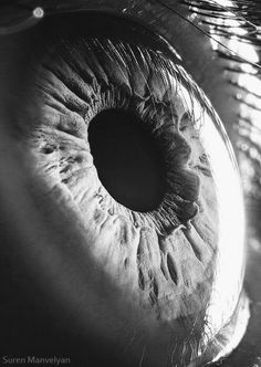 black and white photograph of an eye looking into the distance with only one iris visible