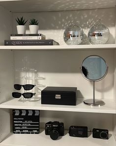 the shelves have various items on them including sunglasses, books, and other things in it