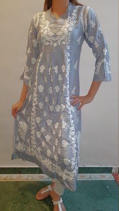 Part of our Capsule Collection, the Exotic Amaya Silk Dress will mesmerize you with its amalgamation of traditional motifs ( Japanese Leaves and Indian Flowers ) fused by the artistic Chikankari embroidery by our skilled Artisans. The Highlight of the dress besides its gorgeous embroidery is the Ruffled neckline with a Yoke on both sides of the garment along with 2 kali panels to add flair as well as Ruffles on the 3/4 sleeve for the vintage Bohemian look. Length - 48 inches Sizes S - fits bust Folk Style Festive Dress With Chikankari Embroidery, Traditional Festive Embroidered Fabric With Tonal Embroidery, Traditional Cotton Dress With Chikankari Embroidery, Folk Style Chikankari Embroidery Dress For Eid, Traditional Straight Kurta Dresses With Floral Embroidery, Traditional Straight Kurta Dresses With Intricate Embroidery, Fitted Traditional Kurta With Tonal Embroidery, Folk Style Festive Dress With Resham Embroidery, Traditional Summer Embroidered Straight Kurta Dress