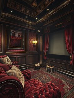 a red couch sitting in the middle of a living room next to a large screen