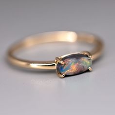 a gold ring with an opal stone in the center