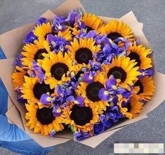 a bouquet of sunflowers and purple irises