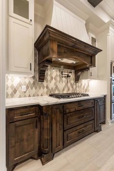 a large kitchen with wooden cabinets and white counter tops, along with an island in the middle