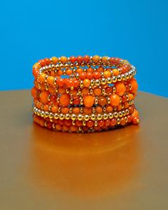 Kelsey Cuff Bracelet in Corals Orange Bohemian Bangle Jewelry, Bohemian Orange Bangle Jewelry, Bohemian Orange Beaded Bracelets With Czech Glass, Bohemian Czech Glass Orange Beaded Bracelets, Bohemian Orange Czech Glass Beaded Bracelets, Bohemian Czech Glass Orange Beaded Bracelet, Orange Stackable Jewelry With Round Beads, Orange Stackable Round Bead Jewelry, Orange Stackable Bracelets With Round Beads