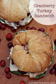 two cranberry turkey sandwiches are shown on a table