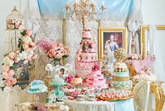 a table topped with lots of cakes and desserts