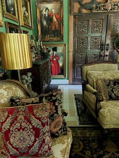 a living room filled with furniture and pictures on the wall