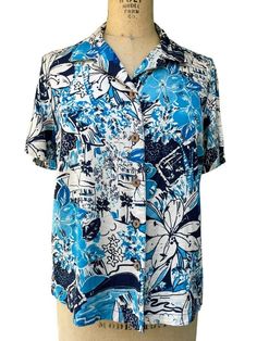 "Karen Scott Sport Womens Hawaiian Shirt Top Blue Floral M Size Medium Tropical Hibiscus Print Collared  Short Sleeve 100% Rayon Casual Vacation Wear Measurements Chest 40\" Waist 40\" Length 23\" Shoulder to Shoulder 15\"" Blue Camp Collar Top For Beach, Blue Camp Collar Tops For The Beach, Blue Floral Print Shirt With Camp Collar, Blue Collared Top For Beach, Blue Camp Collar Top For Vacation, Blue Hawaiian Printed Tops, Blue Printed Tops With Camp Collar, Blue Collared Blouse For Vacation, Blue Hawaiian Relaxed Fit Tops