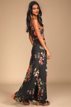 Go ahead, step back and take in the beauty of the Lulus Bloom With a View Black Floral Print Two-Piece Maxi Dress! A moody floral print covers a princess-seamed crop top with a trendy lace-up back. Matching high-waisted, wrapping, maxi skirt completes the set. Fit: This garment fits true to size. Length: Floor length. Size medium Bust: Works best for A to C cup sizes - consider sizing up for fuller bust. Waist: Fitted - very fitted at natural waist. Hip: Not Fitted - room for hips. Undergarments Dress Crop Top, Wrap Maxi Dress, Black Floral Print, Cup Sizes, Step Back, Dress Set, Skirt Dress, Go Ahead, Small Tops