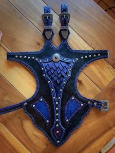 a cowgirl's blue leather corset with studs and chains on it