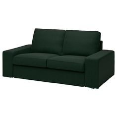 a dark green couch sitting on top of a white floor