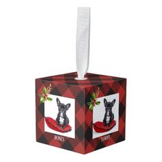 a christmas ornament with a dog on it's head in a red and black box