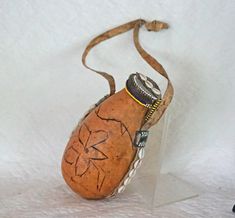 a small wooden bag with an interesting design on it