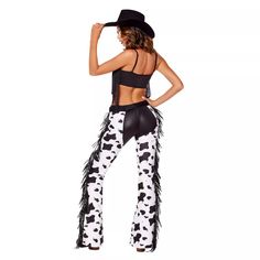 a woman wearing cow print pants and a black top