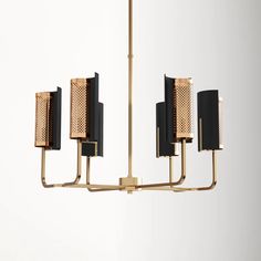 a gold and black chandelier with five lights hanging from it's sides