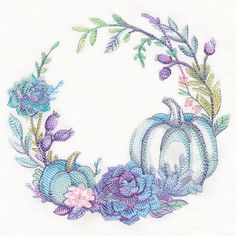 a cross stitched wreath with flowers and pumpkins on the front, in pastel colors