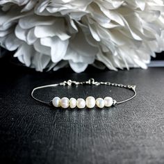 "Lustrous cashmere white Pearls strung on fine sterling silver can be worn as a bracelet or an Anklet. Pearl signifies faith, charity, and innocence. It enhances personal integrity and helps to provide a focus to ones attention. Pearl symbolizes purity and is known as a \"stone of sincerity\". It brings truth to situations and loyalty to a \"cause\". Inhibits boisterous behavior. - 3-5mm Pearls - 3mm Sterling Silver beads - Beads move freely - .5mm Sterling Silver Foxtail Chain - Sterling Silver Minimalist Adjustable Pearl Bracelet For Anniversary, Elegant Adjustable Anklets For Everyday Wear, Adjustable Sterling Silver Wedding Anklets, Adjustable Sterling Silver Anklets For Wedding, White Sterling Silver Anklets As Gift, Dainty Anklet, White Pearl Jewelry, Balance Bracelet, Crystal Properties