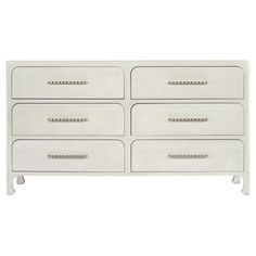 a white dresser with gold handles and drawers