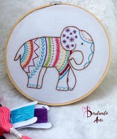 an elephant is shown in this embroidery pattern and it's next to some thread