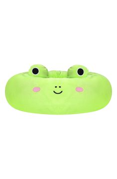 a green pillow with two eyes on it