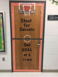 a door decorated with the words shoot for success, one goal at a time and basketball hoop