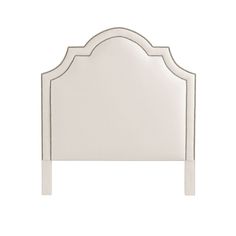 a white headboard with an arched design