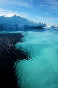 an iceberg floating in the middle of water