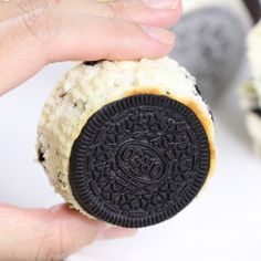 someone holding an oreo cookie in their hand